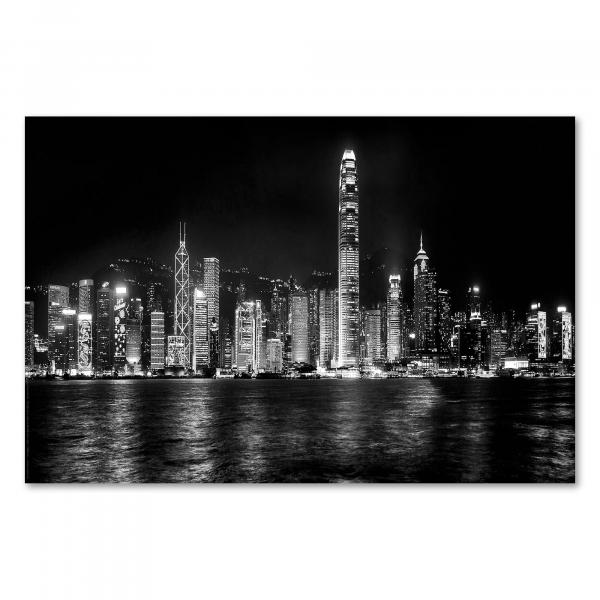 Atemberaubende Schwarzweißfotografie der glitzernden Skyline von Hongkong bei Nacht.